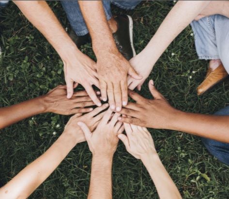 Hands at the center in a group huddle